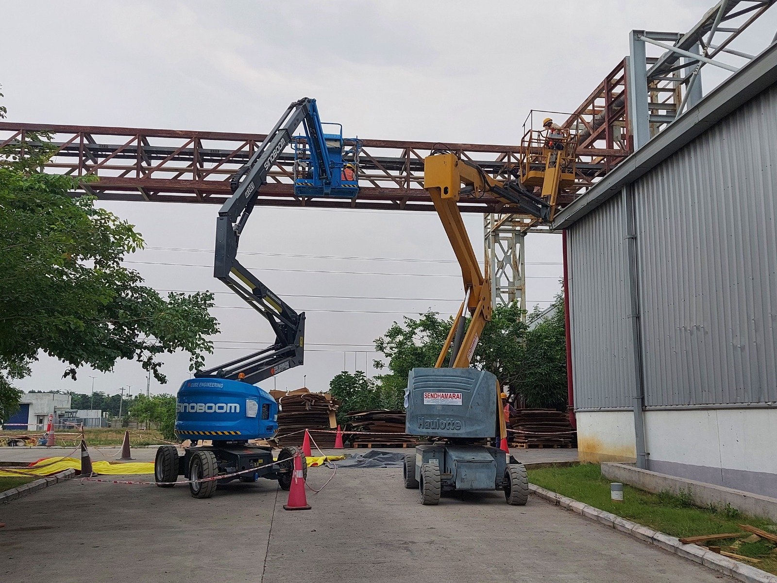 Boom lift structural works on an industrial building frame