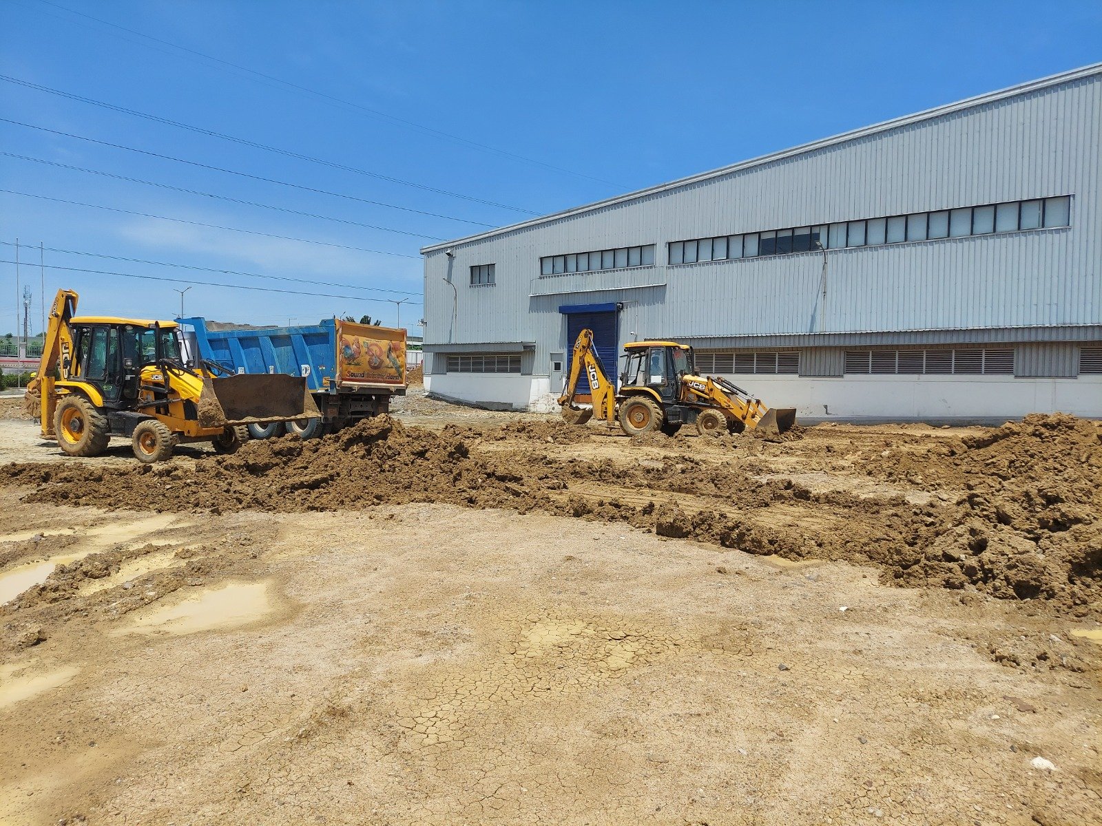 JCB loaders loading excavated soil during industrial earthwork