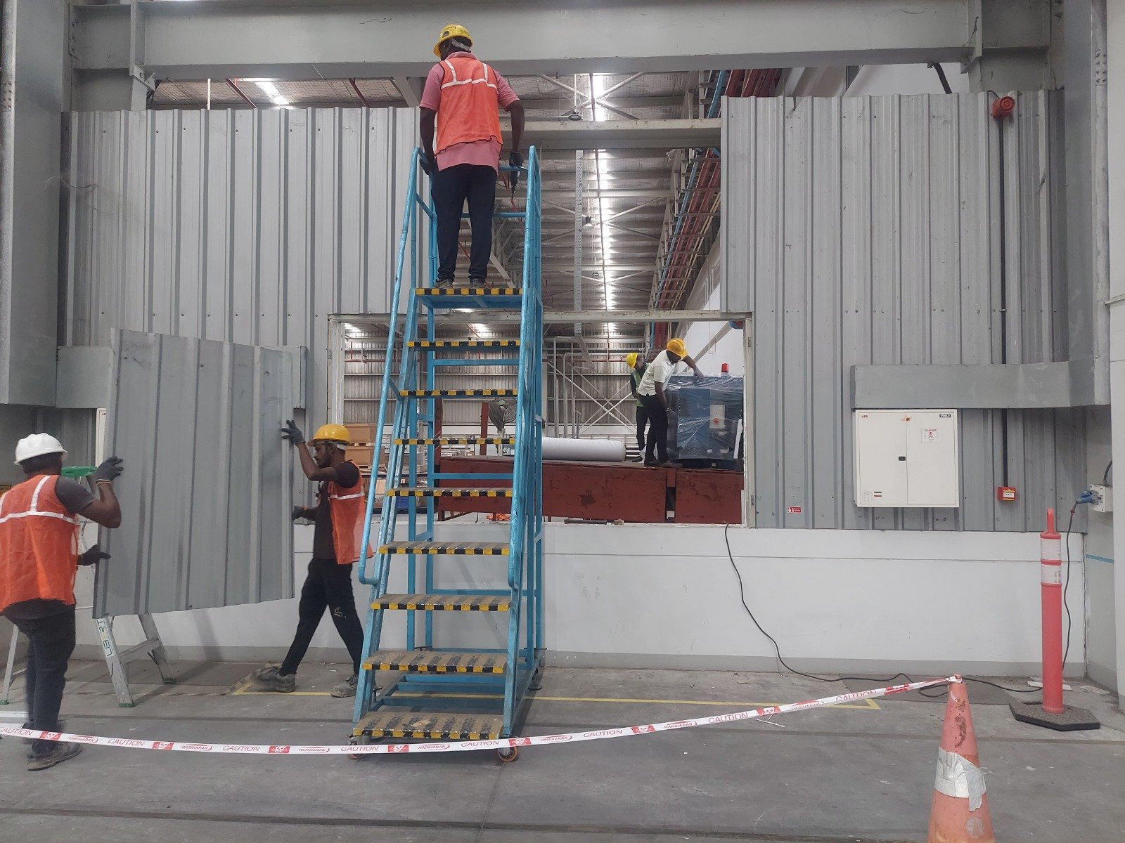 Interior wall panel installation inside an industrial building