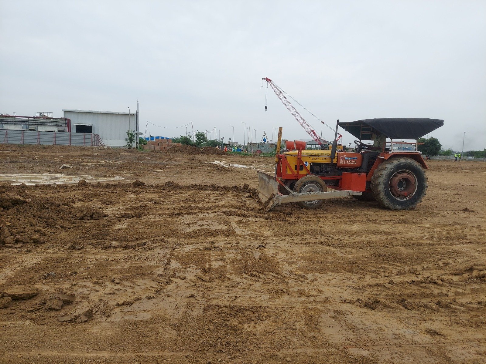 Industrial land leveling works with a crawler crane on the facility site