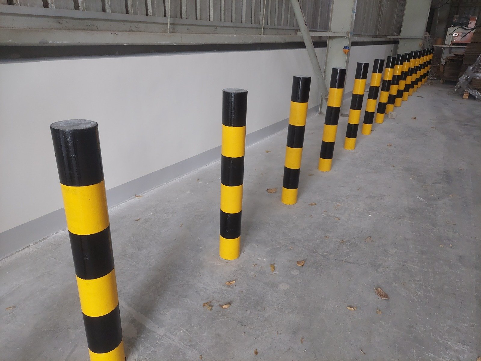 Safety bollard installation along an industrial access route
