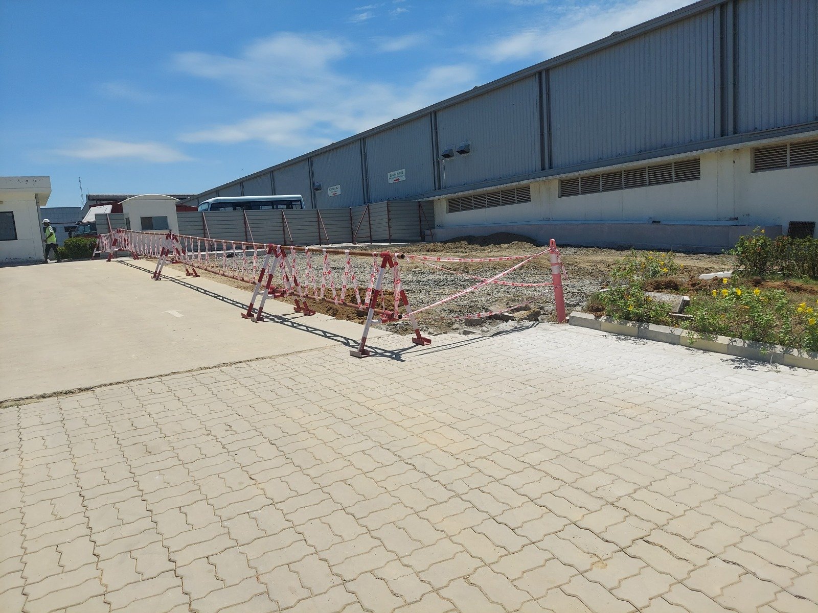 Site barricades and a protected walkway at the industrial entrance