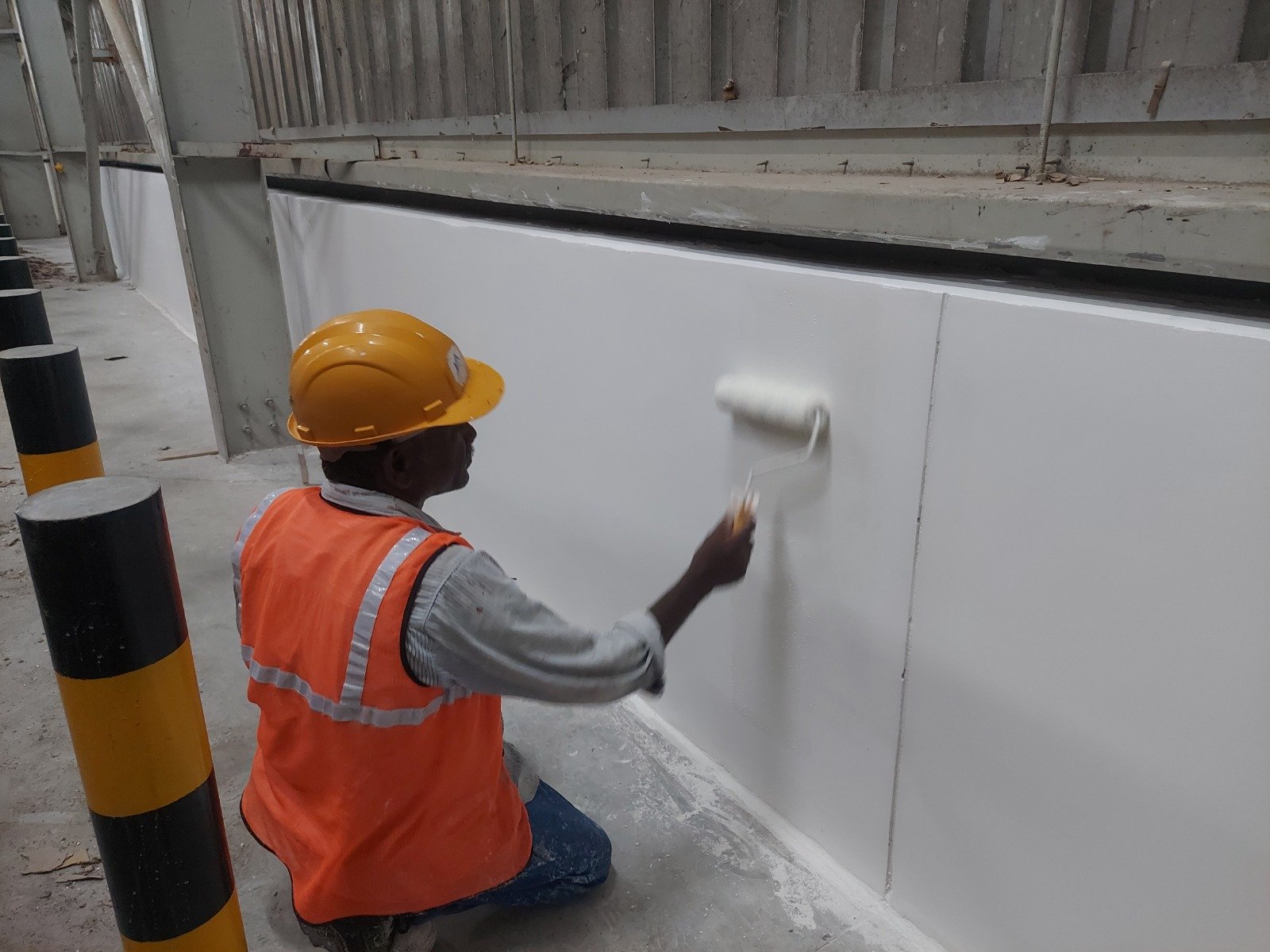 Waterproof coating applied to an industrial building wall