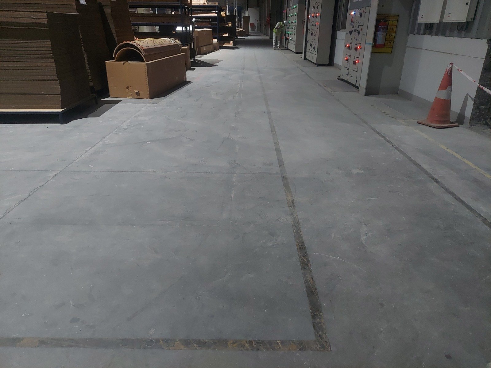 Completed industrial warehouse flooring with marked circulation aisles