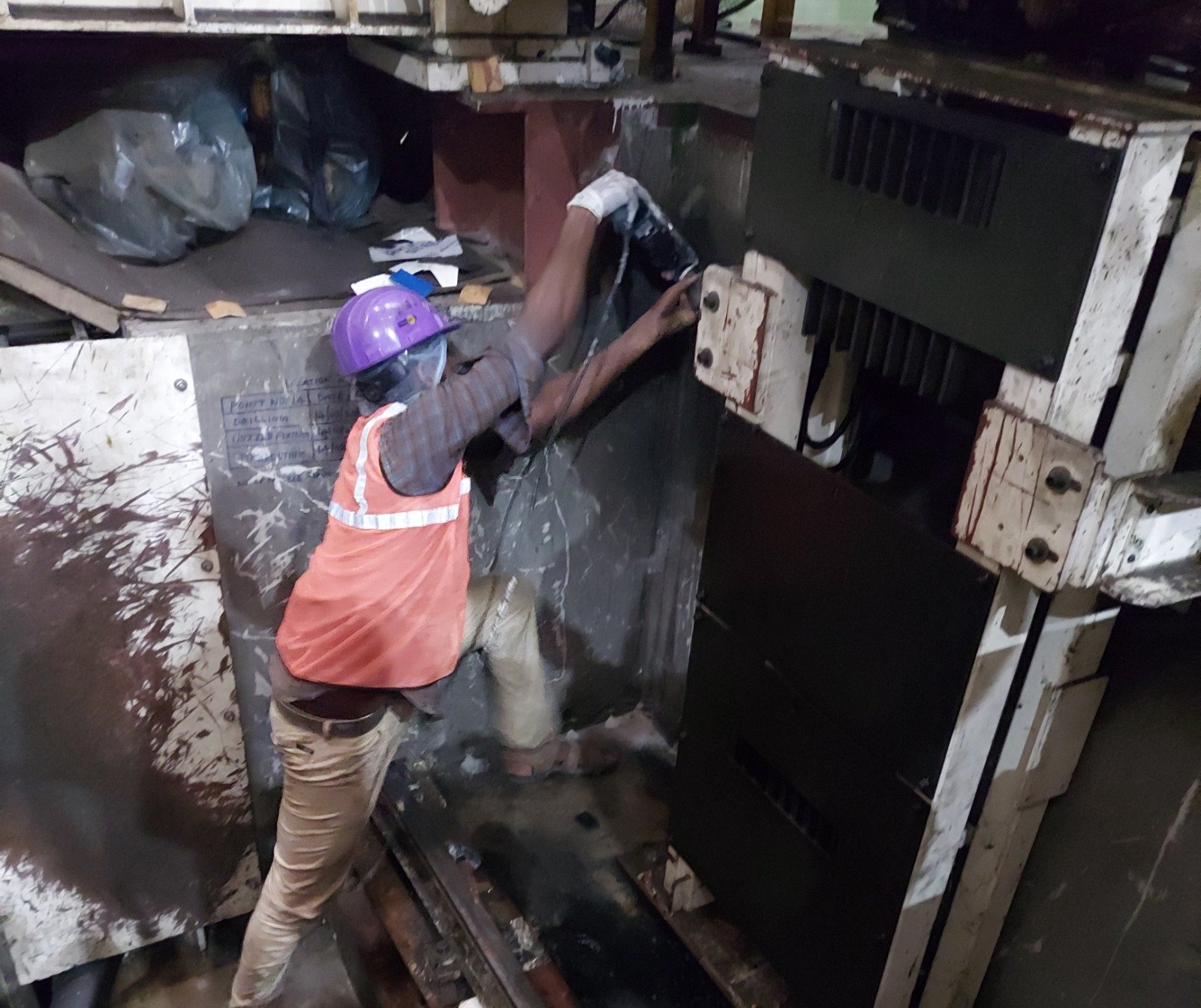 Site team applying PU flooring material in an industrial plant